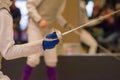 Fencer holding a foil and preparing to fight