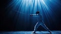 A fencer in protective equipment stands in competition stance with foil ready for competition, with spectacular lighting