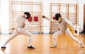 fencers at fencing workout, practicing attack movements