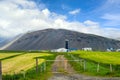 Fences and driveways for farms and small villages have green pastures. In the countryside of Iceland