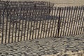Fences throw Shadows on the Beach Royalty Free Stock Photo
