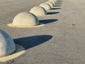 Fencing on the asphalt road in the form of large hemispheres