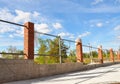 Fencing construction. Bricklaing brick pillar or column with iron bars for new fence.