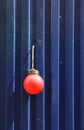 Fencing of construction site with red construction light on the background of blue profiled sheet fence