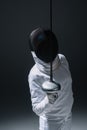 In fencing mask holding rapier on Royalty Free Stock Photo
