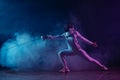 Fencing with rapier on black background