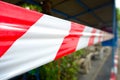 Fencing red and white ribbon which prohibits movement. Royalty Free Stock Photo