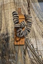 Fender on iron chain made of rubber at a fishing boat, and fishing net. Royalty Free Stock Photo