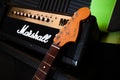 Fender Jaguar guitar headstock with amp in background