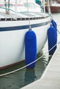 Fenders suspended between a boat and dockside for protection. Maritime fenders Royalty Free Stock Photo