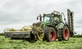 Fendt green tractor with claas mowers in silage field Royalty Free Stock Photo