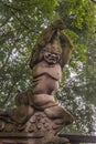 Brown stone clubbing monster statue at religious Ghost City, Fengdu, China