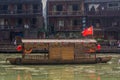 FENGHUANG, CHINA - AUGUST 14, 2018: Boat with hammer and sickle flag on Tuo river in Fenghuang Ancient City, Hunan Royalty Free Stock Photo
