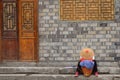 Fenghuang, China - May 15, 2017: Woman rest on street in the Phoenix Fenghuang City