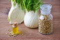 Fennel bulb and seeds, oil, selective focus on dark wooden Royalty Free Stock Photo