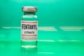 A Fentanyl Citrate vial on a green background