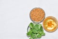 Fenugreek leaves with seeds and oil over white background. Concept of Indian ayurvedic medicine for blood suger, and damage hair Royalty Free Stock Photo