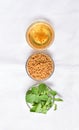 Fenugreek leaves with seeds and oil over white background. Concept of Indian ayurvedic medicine for blood suger, and damage hair Royalty Free Stock Photo