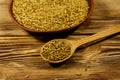 Fenugreek seeds in ceramic plate on wooden table Royalty Free Stock Photo