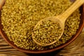 Fenugreek seeds in ceramic plate on wooden table Royalty Free Stock Photo