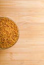 Fenugreek seeds in glass bowl and scoop on wooden background Royalty Free Stock Photo