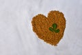 Fenugreek Seeds (Methi Dana) and leaves in heart shape Royalty Free Stock Photo