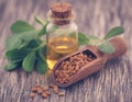 Fenugreek seeds with oil in bottle Royalty Free Stock Photo