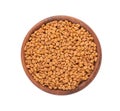 Fenugreek seeds in wooden bowl, isolated on white background. Shambala, helba seeds. Top view. Royalty Free Stock Photo