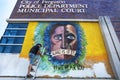 Ferguson, Missouri, USA, June 20, 2020 - artist painting black and white faces mural on Ferguson Missouri Police Station