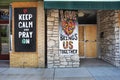 Ferguson, Missouri, USA, June 20, 2020 - keep calm and pray on sign painted on Ferguson Missouri business boarded up windows after