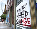 Ferguson, Missouri, USA, June 20, 2020 - We need change sign painted on boarded up business windows after police brutality riots Royalty Free Stock Photo