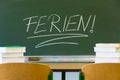 School holidays is written at the school blackboard, in German Royalty Free Stock Photo