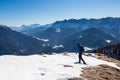 Ferlacher Horn - Man on panoramic hiking trail on way to snow covered mountain peak Ferlacher Horn in Carinthia