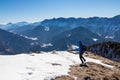 Ferlacher Horn - Man on panoramic hiking trail on way to snow covered mountain peak Ferlacher Horn in Carinthia