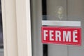 Ferme means in french closed on text sign board red on windows shop restaurant cafe store signboard