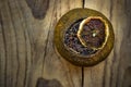 Fermented aged black chinese puer tea in a tangerine dry peel with lid, weathered wood background, top view