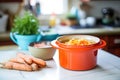 fermented carrot and ginger mix in a ceramic crock on a kitchen counter Royalty Free Stock Photo