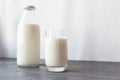 Fermented dairy products. Milk, kefir in a glass bottle and a glass. Farm rustic drinks on a gray wooden background. Royalty Free Stock Photo