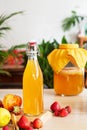 Fermented drink, kombucha in glass bottle with with fruits and Berries