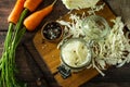 Fermented food. Prepare homemade sauerkraut jars with and carrot on rustic wooden table.