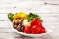 Fermented food on a white plate. Pickled tomatoes, cucumbers, sauerkraut, pickled champignon mushrooms closeup and copy space Royalty Free Stock Photo