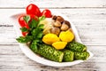 Fermented food on a white plate. Pickled tomatoes, cucumbers, sauerkraut, pickled champignon mushrooms closeup and copy space Royalty Free Stock Photo