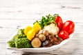 Fermented food on a white plate. Pickled tomatoes, cucumbers, sauerkraut, pickled champignon mushrooms closeup and copy space