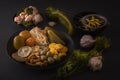 Fermented foods cabbage, peppers, pickles, tomatoes, mushrooms, zucchini, garlic in a large wooden dish on a dark table Royalty Free Stock Photo