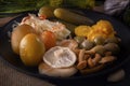 Fermented foods cabbage, peppers, pickles, tomatoes, mushrooms, zucchini, garlic in a large wooden dish on a dark table Royalty Free Stock Photo
