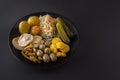 Fermented foods cabbage, peppers, pickles, tomatoes, mushrooms, zucchini, garlic in a large wooden dish on a dark table Royalty Free Stock Photo