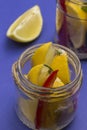 Fermented lemons with salt and chili pepper in jars