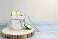 Fermented milk in the glass jar and silver spoon. A glass of organic probiotic yogurt drink and a cucumber on wooden background. Royalty Free Stock Photo
