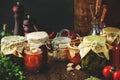 Fermented, pickled, marinated preserved vegan food. Organic vegetables and fruits in jars with spice and herbs on black kitchen Royalty Free Stock Photo