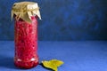 Fermented pickled vegetables. red cabbage with beets and bay leaves in a glass tall jar on a classic blue background Royalty Free Stock Photo
